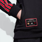 Detailed zoom on the ribbed cuffs and hem, showcasing the precision stitching and the quality of the recycled materials.