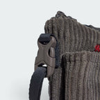 Highlights the technical strap adjusters and the "unreal" finish of the corduroy ribs.