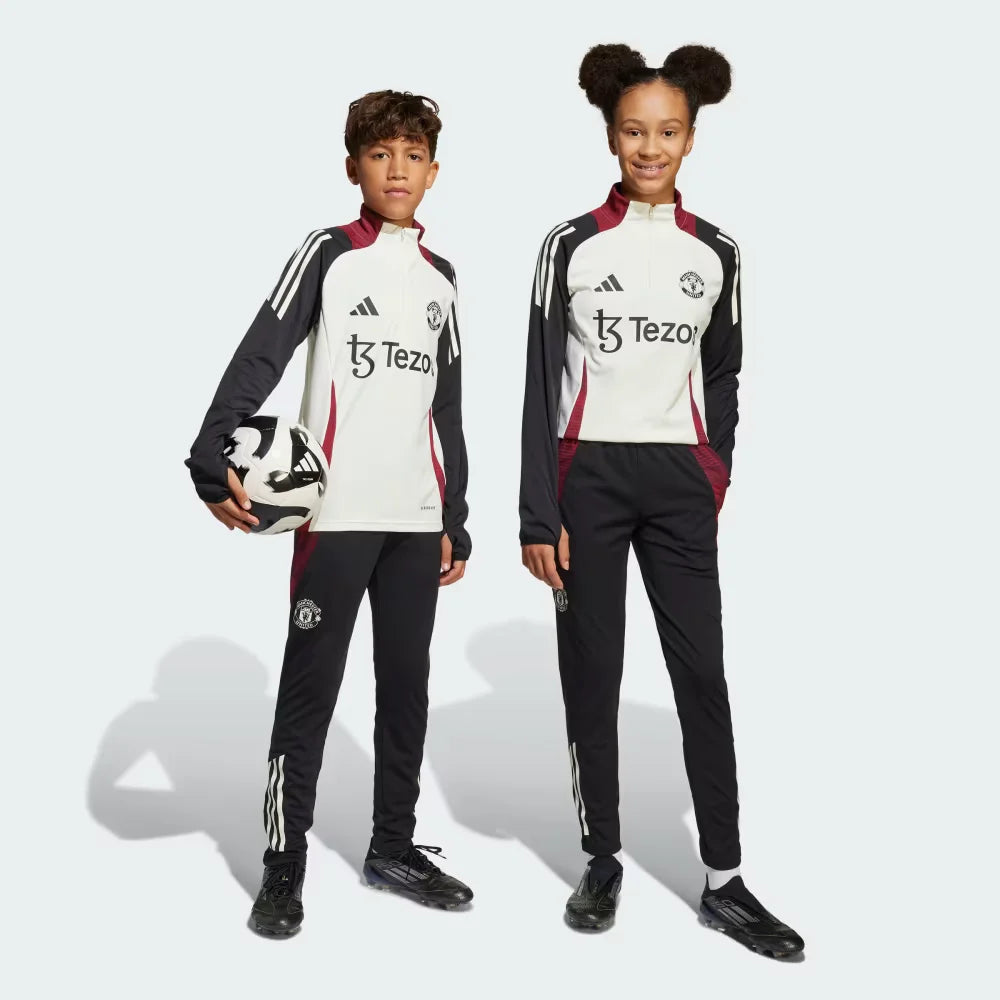 Side profile of the Kids' Man Utd Tiro 24 pants, highlighting the slim, tapered leg and the classic white 3-Stripes branding.