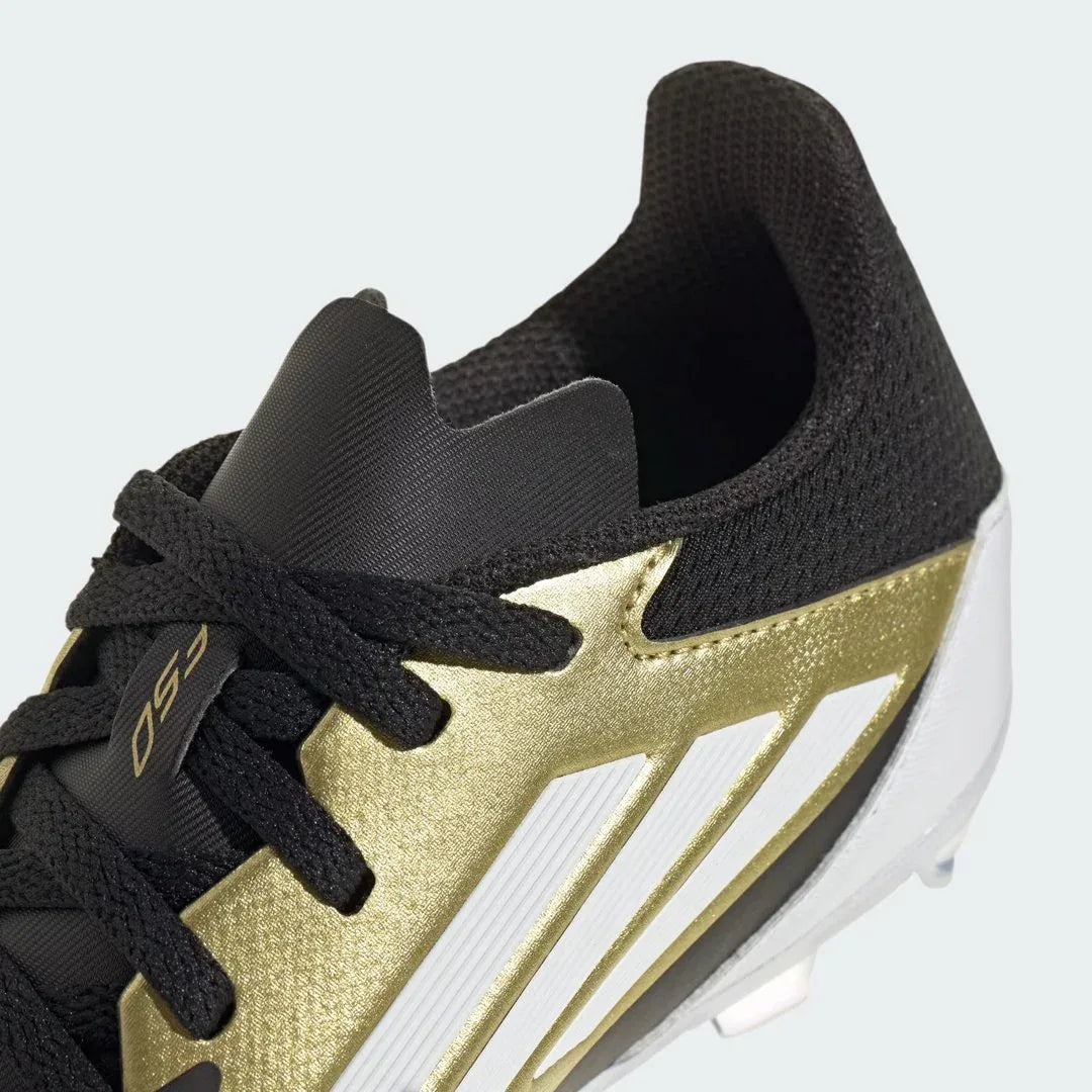 Detailed zoom on the sole of the Adidas Messi F50 League FG/MG Juniors' boots, highlighting the FG/MG stud pattern and cushioned midsole.