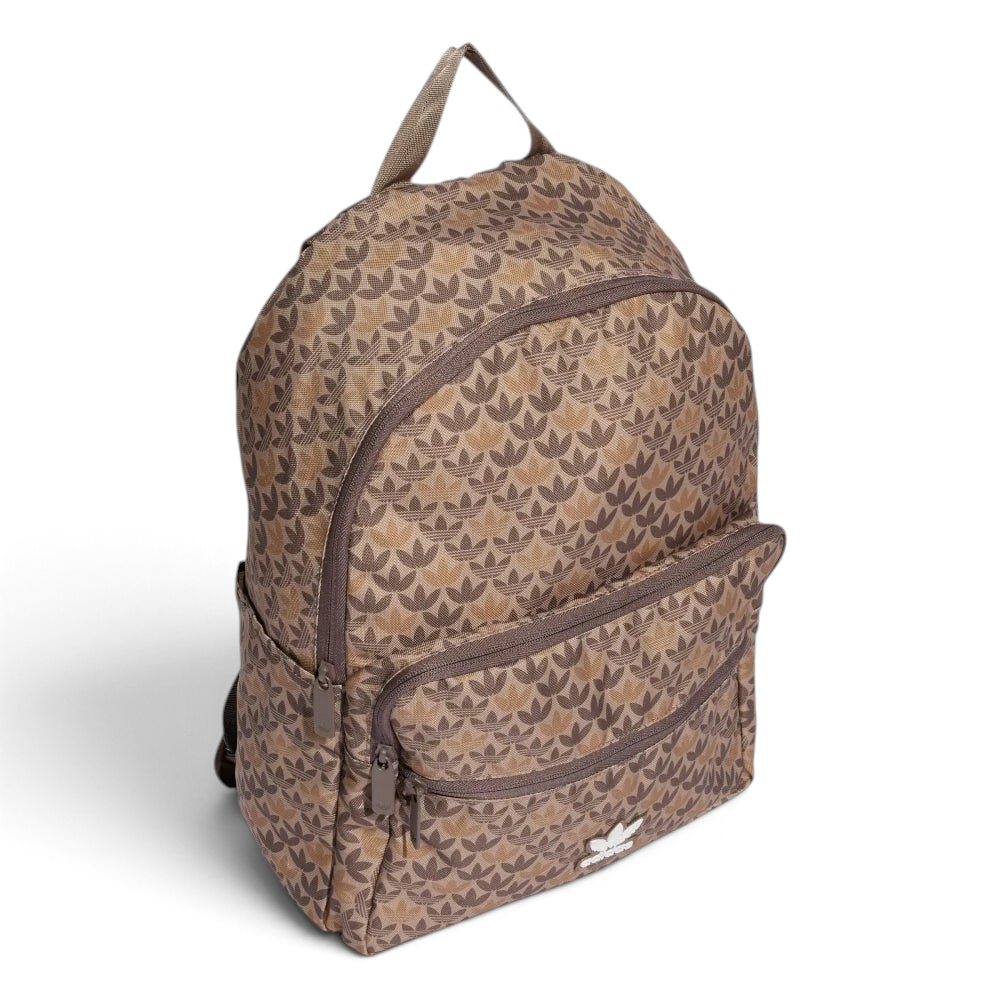 Highlights the backpack sitting at a three-quarter angle, showing the depth of the front zip pocket compartment and the streamlined slip-in pocket on the flank.