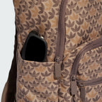 Details a close-up view of the side slip-in pocket holding a pair of sunglasses, framing the color-matched brown zipper tracks and custom metal Trefoil pull tabs.