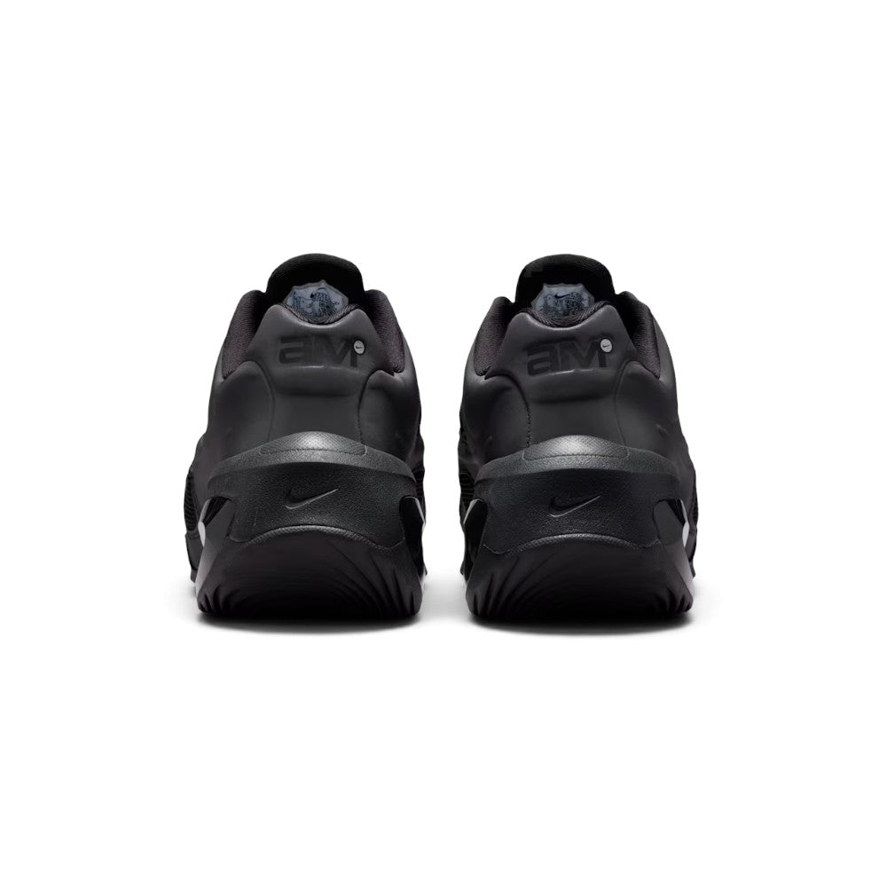 Focuses on the rear profile, highlighting the raised black heel counters stamped with debossed "aM" Air Max logos, and the wide flared footprint of the sculpted black foam heel base.