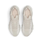 Focuses on the locked-in central lacing layout, displaying the perforated forefoot toe box, Phantom laces, padded ankle collar, and tonal insoles printed with Nike branding.