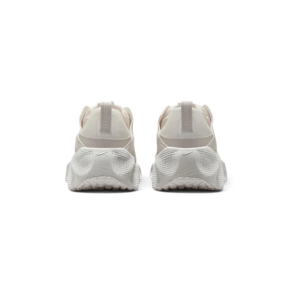 Focuses on the rear profile, highlighting the supportive heel counter, subtle pull tab details, and the wide, stacked footprint of the ReactX foam midsole base.