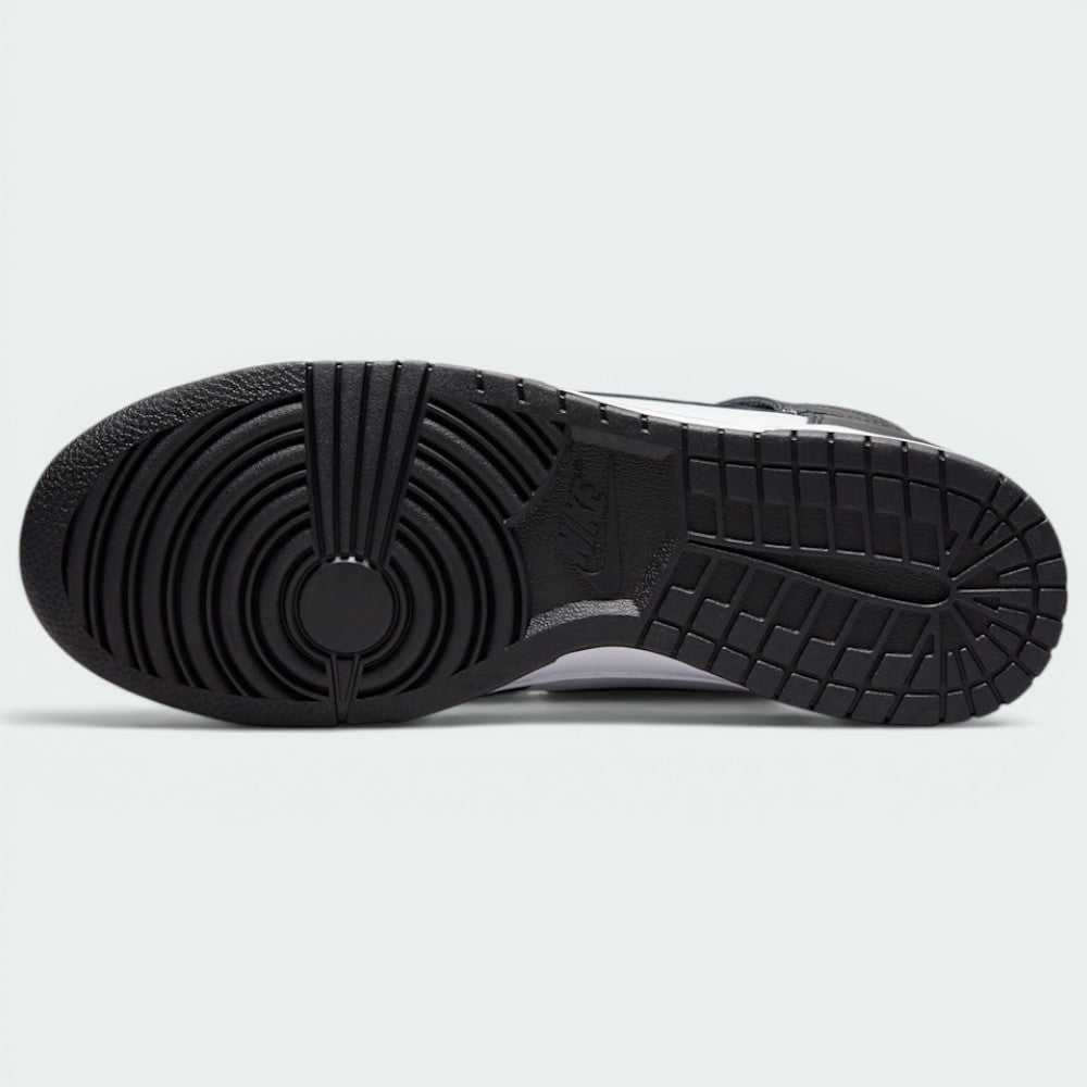 Displays the full-length solid black rubber sole, showcasing the classic basketball pivot-circle traction grid engineered for unreal multi-surface street grip.