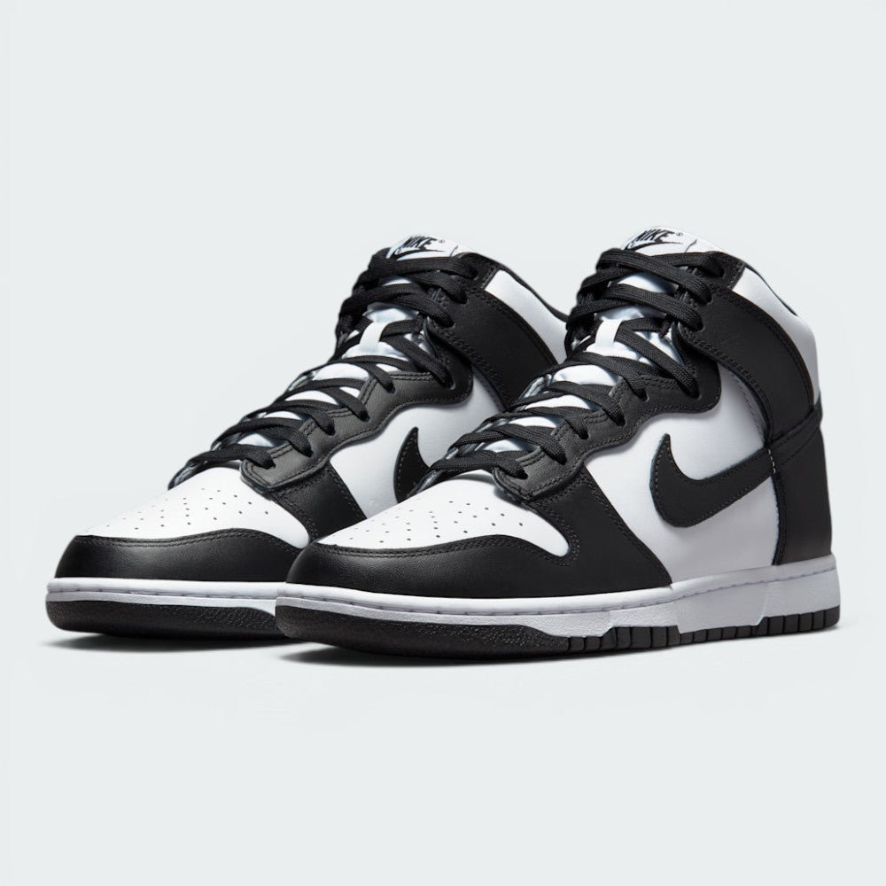 Emphasising the aggressive, forward-leaning basketball stance of the high-tops and the striking monochrome contrast between the white bases and black overlays.