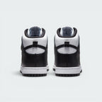 Focuses on the rear profile, highlighting the structured black leather heel counters, the white collar overlay, the black leather pull loops, and the sturdy white rubber midsole base.
