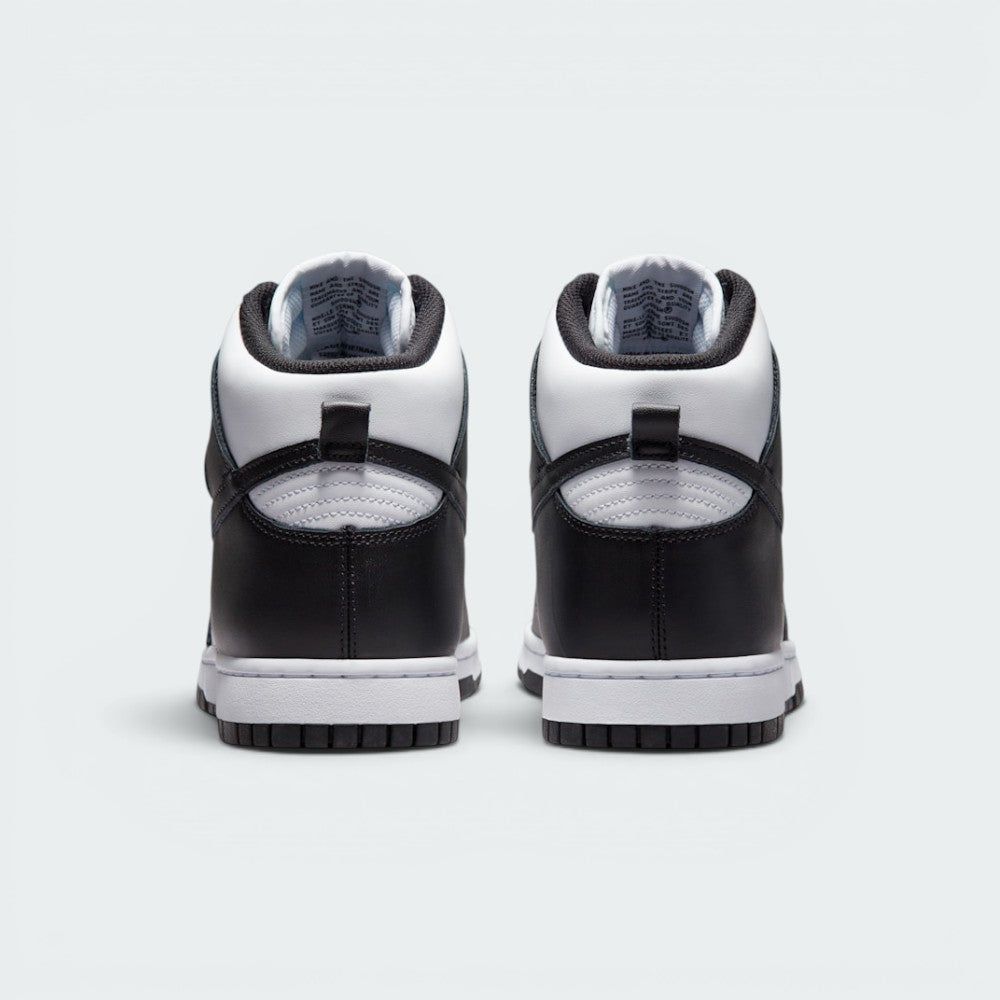 Focuses on the rear profile, highlighting the structured black leather heel counters, the white collar overlay, the black leather pull loops, and the sturdy white rubber midsole base.