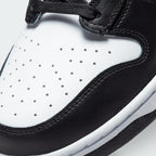 Details the micro-precision of the perforated white leather toe box, showing the double-stitched black toe mudguard and the neat tracking of the black laces.