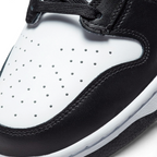 Details the micro-precision of the perforated white leather toe box, showing the double-stitched black toe mudguard and the neat tracking of the black laces.