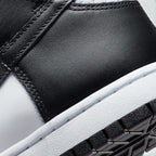 Highlights the "unreal" clean finish where the smooth white rubber midsole meets the textured black leather upper and the durable black pivot-circle rubber tread below.