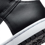 Highlights the "unreal" clean finish where the smooth white rubber midsole meets the textured black leather upper and the durable black pivot-circle rubber tread below.