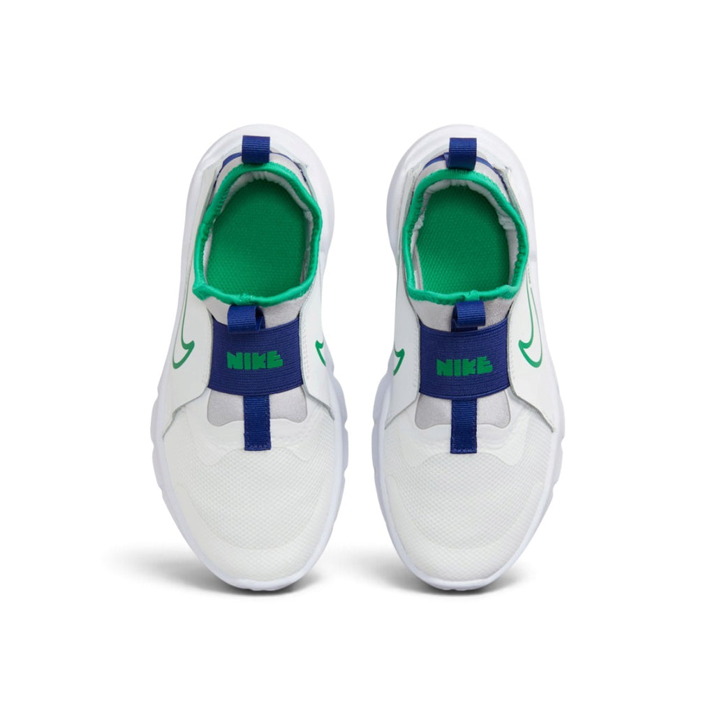 Overhead view looking down at the laced-free children's shoes, displaying the blue elastic midfoot straps featuring bold green "NIKE" lettering and the bright green cushioned insoles.