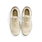 Direct overhead view of both shoes laid flat, showcasing the uniform khaki mesh toe box, the parallel webbed lace loops, the branded tongue tabs reading "NIKE FREE", and the printed Metcon insoles