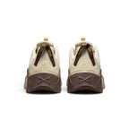 Close-up rear angle focusing on the stable chocolate-brown heel counter with an embossed cross-training graphic, vertical striped pull tabs, and the flared rear stability base.