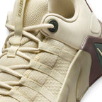 Macro focus on the midfoot lacing zone, detailing the robust webbed strap eyelets, the metal-accented top lace anchor stamped with "METCON", and the fine mesh texture.