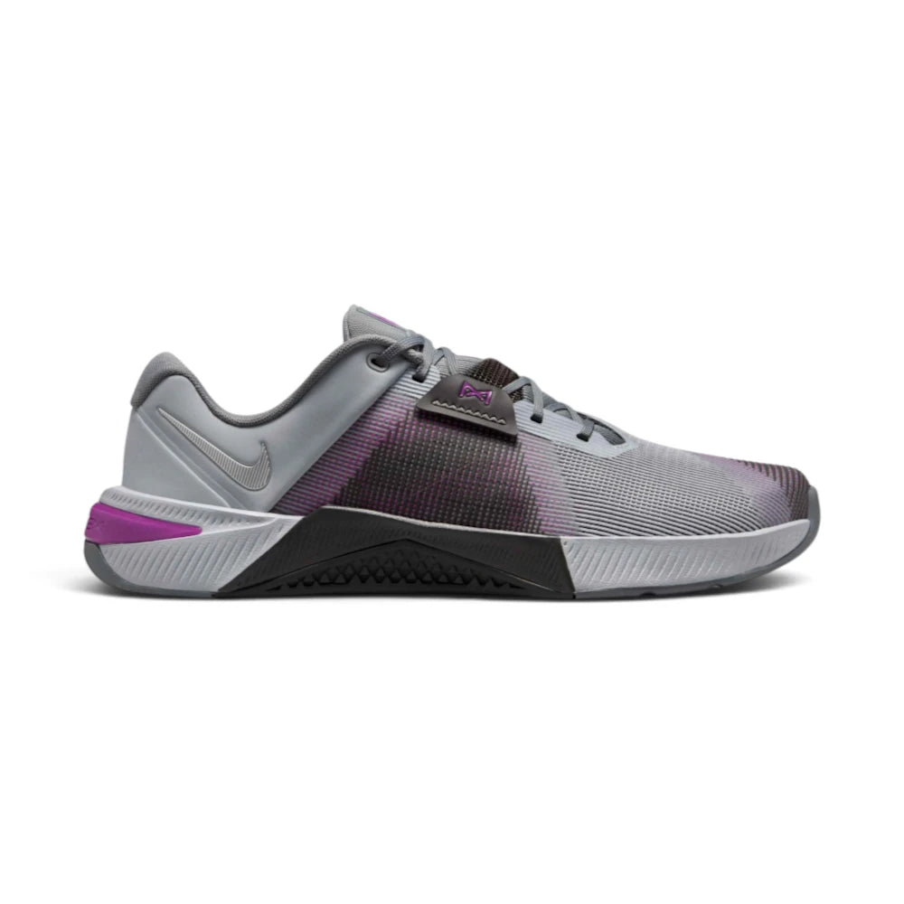 Highlights the lateral profile featuring the Wolf Grey open-holed mesh upper, dark Medium Ash midfoot wrap with Vivid Purple underlay dots, black lace tuck band, metallic silver micro-Swoosh on the heel counter, and the Vivid Purple plastic HSPU heel clip set into the grooved grey ReactX midsole.