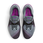 Focuses on the locked-in central lacing layout, displaying the Wolf Grey mesh tongues with purple Metcon emblem badges, matching laces held down by the black "LACE TUCK" strap, padded ankle collars, and bright Vivid Purple insoles printed with black Metcon branding.