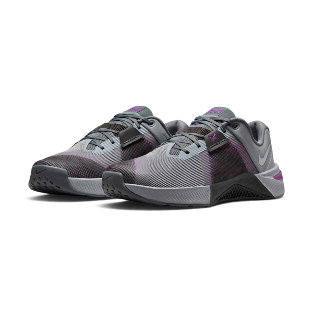 Emphasising the wide, grounded stance of the cross-training shoes and the dark-to-light gradient contrast across the engineered mesh toe box and lateral rubber stability wraps.