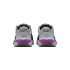 Focuses on the rear profile, highlighting the grey synthetic heel counters, wide flared ReactX foam base, and the prominent Vivid Purple plastic heel clip stamped with debossed "METCON" lettering.