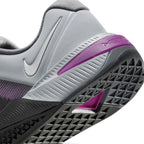 Highlights the "unreal" clean finish where the grooved grey foam midsole carrier meets the triangular rubber outsole tread, framing the metallic silver heel Swoosh and Vivid Purple Hyperlift window.