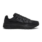 Highlights the early-2000s lateral silhouette featuring the stealth black mesh upper, horizontal and vertical leather lattice overlays, glossy moulded black Nike Swoosh, sculpted black foam midsole, and black rubber outsole.