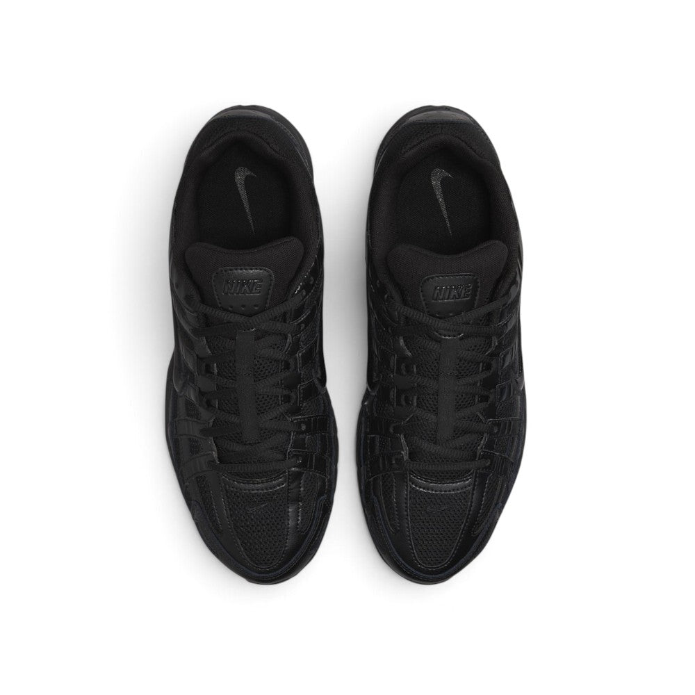 Focuses on the locked-in central lacing layout, displaying the flat black laces, vertical tongue webbing stamped with "Bowerman Series" text, padded mesh tongues with embossed Nike branding tabs, and black insoles printed with grey Swooshes.