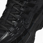 Details the micro-precision of the forefoot area, showing the open-weave black mesh toe box, stitched leather toe bumper, flat black laces, and central tongue webbing strip.