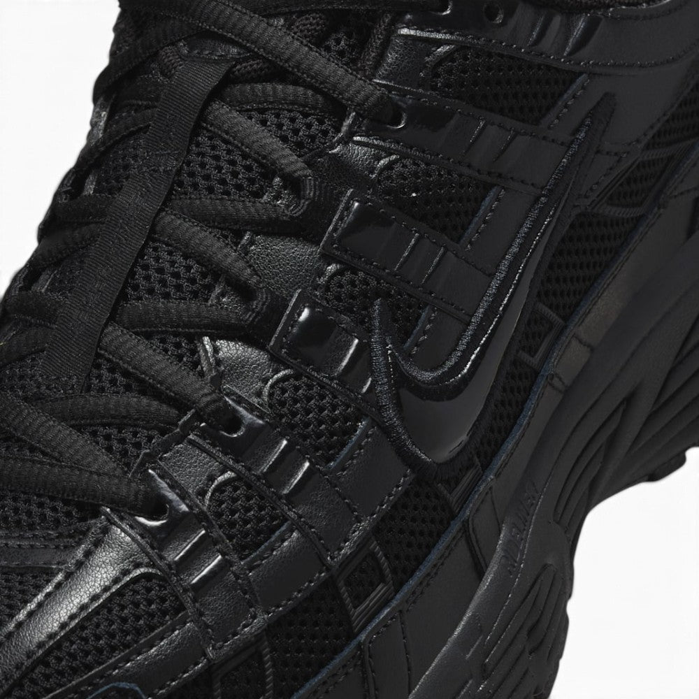 Details the micro-precision of the forefoot area, showing the open-weave black mesh toe box, stitched leather toe bumper, flat black laces, and central tongue webbing strip.