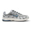 Highlights the early-2000s lateral silhouette featuring the Summit White mesh upper, layered grey and silver cross-hatch overlays, slate-blue Nike Swoosh with black embroidered trim, vintage Sail foam midsole with blue heel insert, and black rubber outsole.