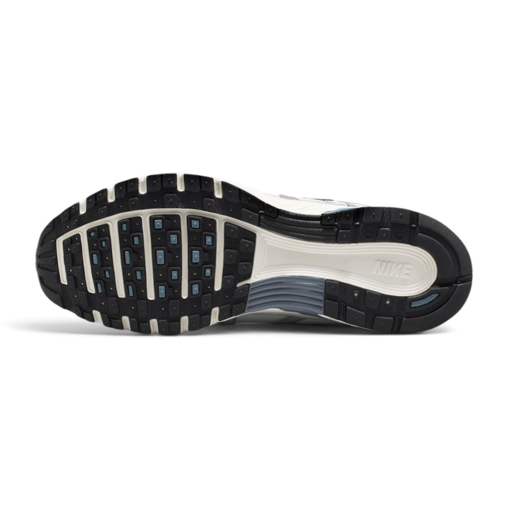 Displays the full-length black and Sail rubber outsole, showcasing the multi-pod waffle traction pattern, grooved forefoot flex channels, debossed Nike branding, and BRS 1000 heel rubber badge.