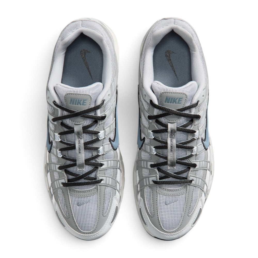 Focuses on the locked-in central lacing layout, displaying the flat dark grey laces, vertical tongue webbing stamped with "Bowerman Series" text, grey mesh tongues with Nike branding tabs, and cushioned grey insoles printed with black Swooshes.