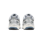 Focuses on the rear profile, displaying the structured grey synthetic heel counters, micro blue Swooshes, ventilation perforations, and the multi-layered Sail and blue foam midsole base.