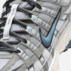 Details the micro-precision of the forefoot area, showing the textured white mesh toe box, synthetic leather toe cap, striped eyelet webbing loops, and central "Bowerman Series" tongue strip.