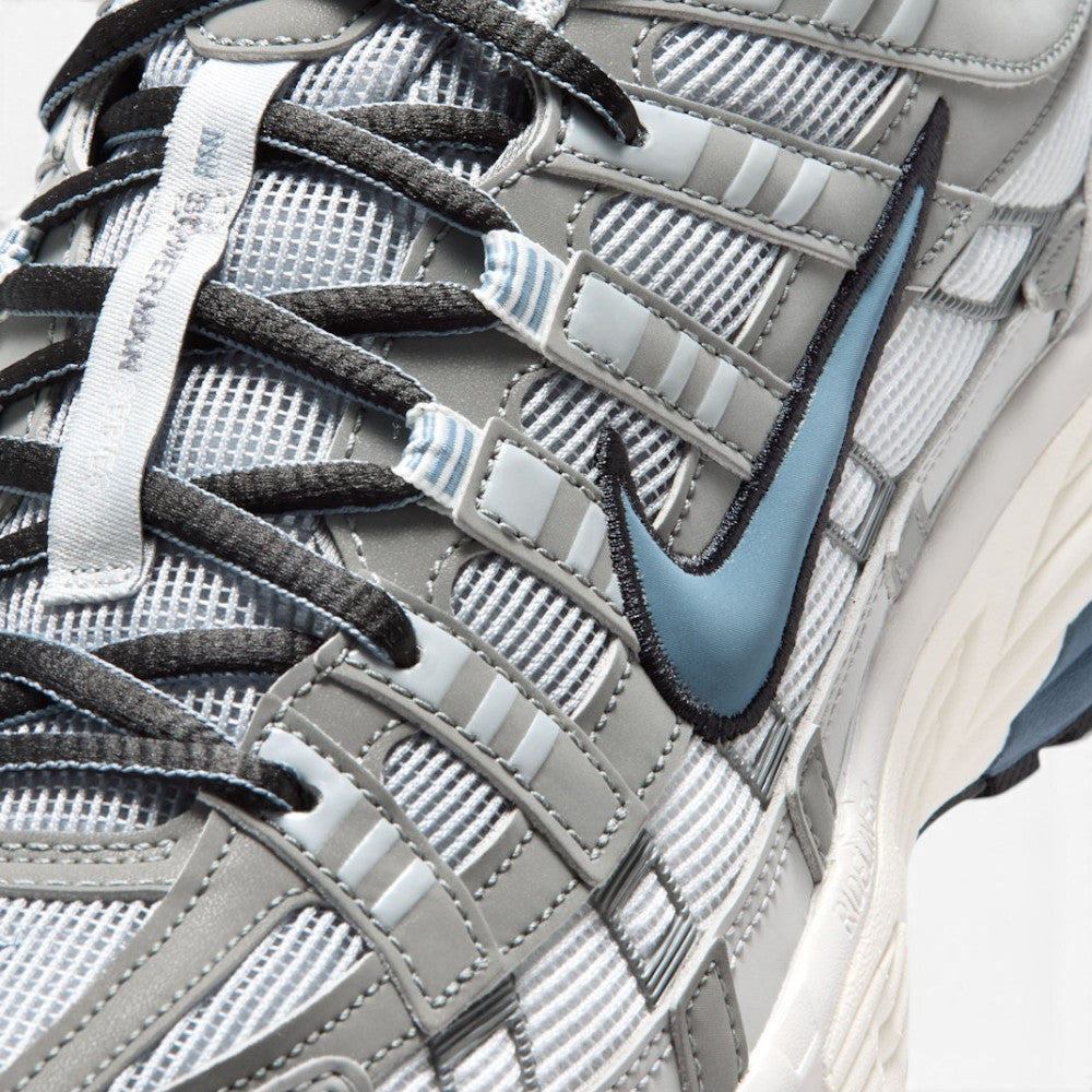 Details the micro-precision of the forefoot area, showing the textured white mesh toe box, synthetic leather toe cap, striped eyelet webbing loops, and central "Bowerman Series" tongue strip.