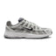 Highlights the early-2000s lateral silhouette featuring the Atmosphere Grey mesh upper, layered Vast Grey and silver leather lattice overlays, moulded synthetic leather Nike Swoosh with black outline, clean foam midsole, and black rubber outsole.