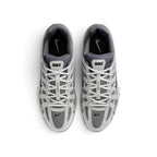 Focuses on the locked-in central lacing layout, displaying the flat grey laces, vertical tongue webbing stamped with "Bowerman Series" text, padded mesh tongues with Nike logo tabs, and cushioned insoles.