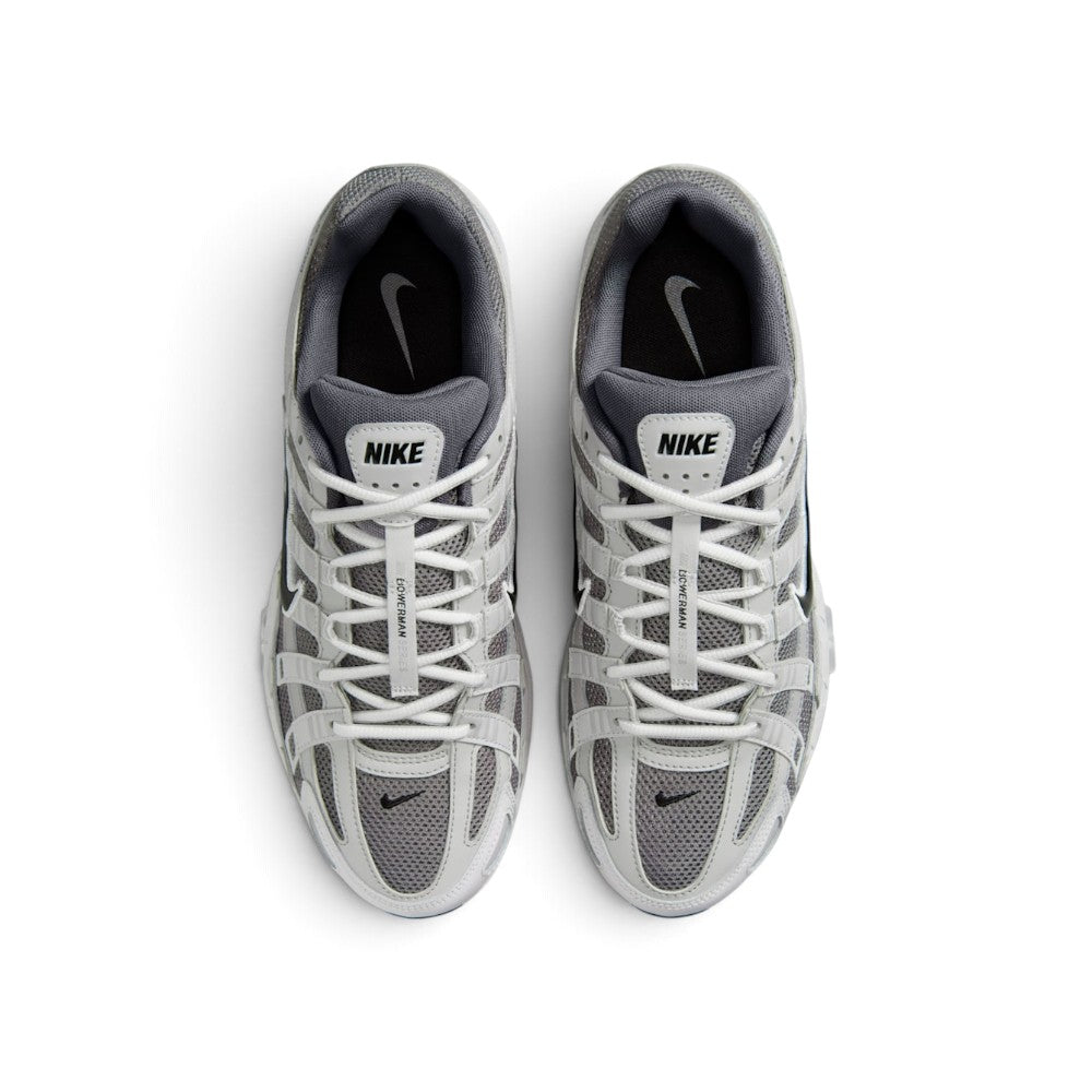 Focuses on the locked-in central lacing layout, displaying the flat grey laces, vertical tongue webbing stamped with "Bowerman Series" text, padded mesh tongues with Nike logo tabs, and cushioned insoles.