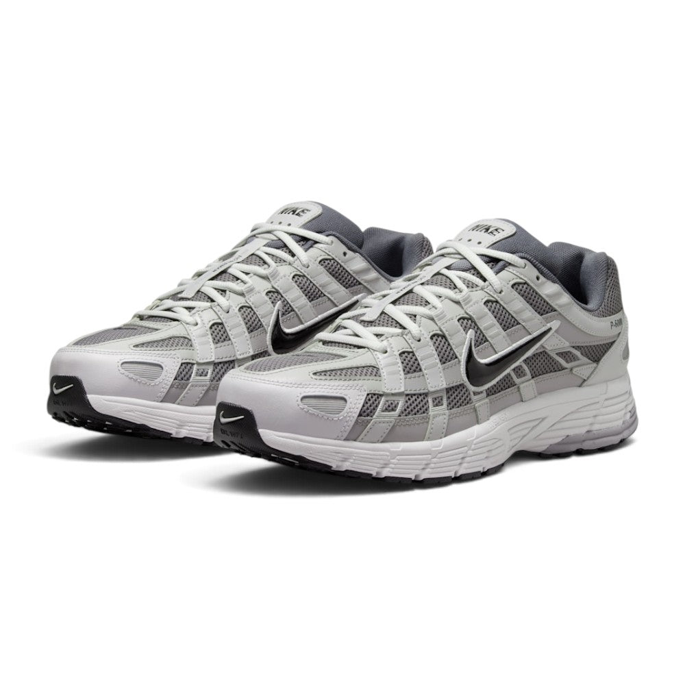 Emphasising the low-slung, technical stance of the trainers and the crisp harmony between the breathable grey mesh base, metallic leather cage panels, and subtle Pencil Point accent lines.