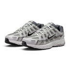 Emphasising the low-slung, technical stance of the trainers and the crisp harmony between the breathable grey mesh base, metallic leather cage panels, and subtle Pencil Point accent lines.