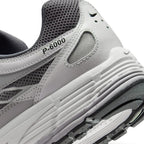 Highlights the "unreal" clean finish of the rear lateral tooling, showcasing the debossed "P-6000" collar script, ribbed foam midsole, and lugged rubber outsole tread.