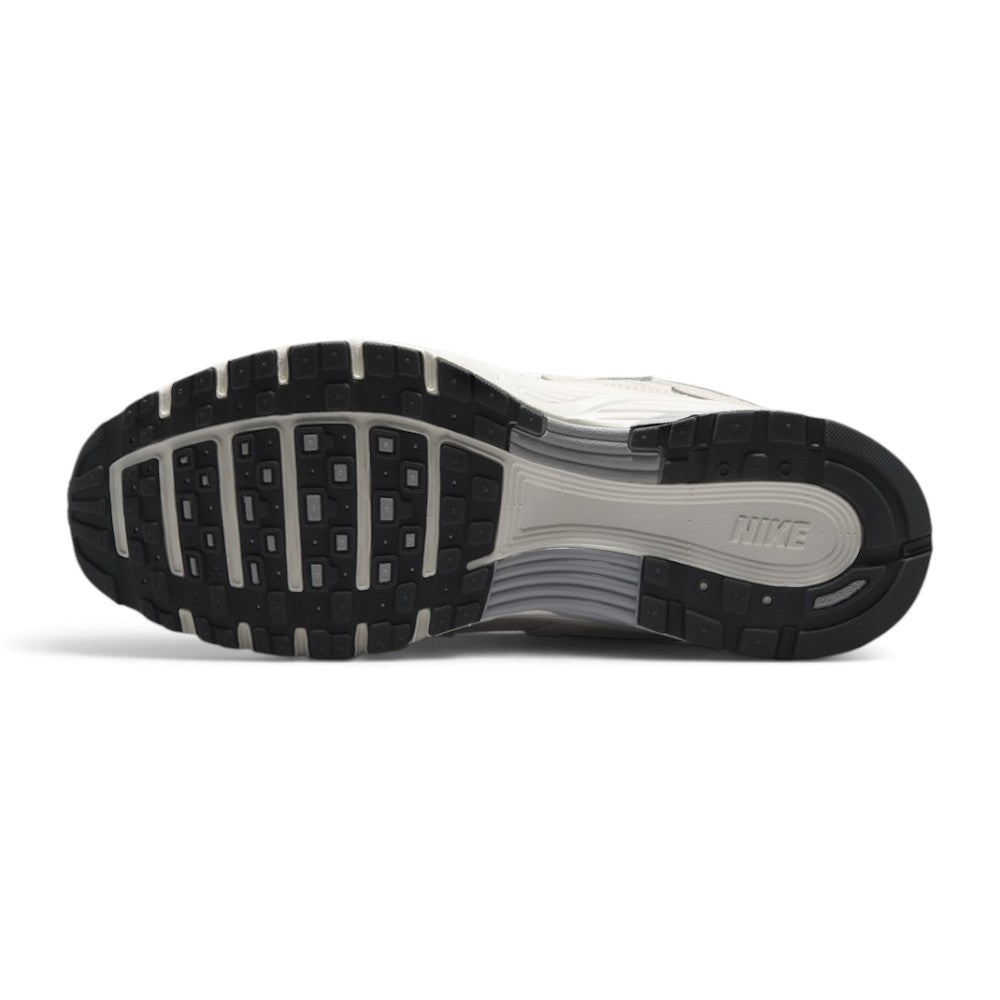 Displays the full-length rubber outsole, showcasing the multi-pod waffle traction pattern, grooved forefoot flex channels, debossed Nike branding, and high-abrasion rubber pods.