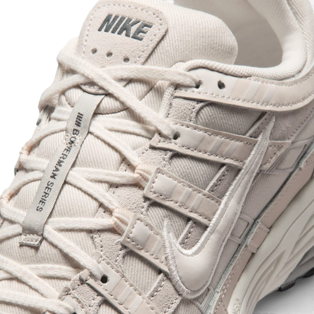 Details the micro-precision of the forefoot area, showing the textured Phantom mesh toe box, protective leather toe cap, flat laces, and central tongue webbing strip.