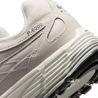 Highlights the "unreal" clean finish of the rear lateral tooling, showcasing the debossed "P-6000" collar script, ribbed Sail foam midsole, and lugged rubber outsole tread.