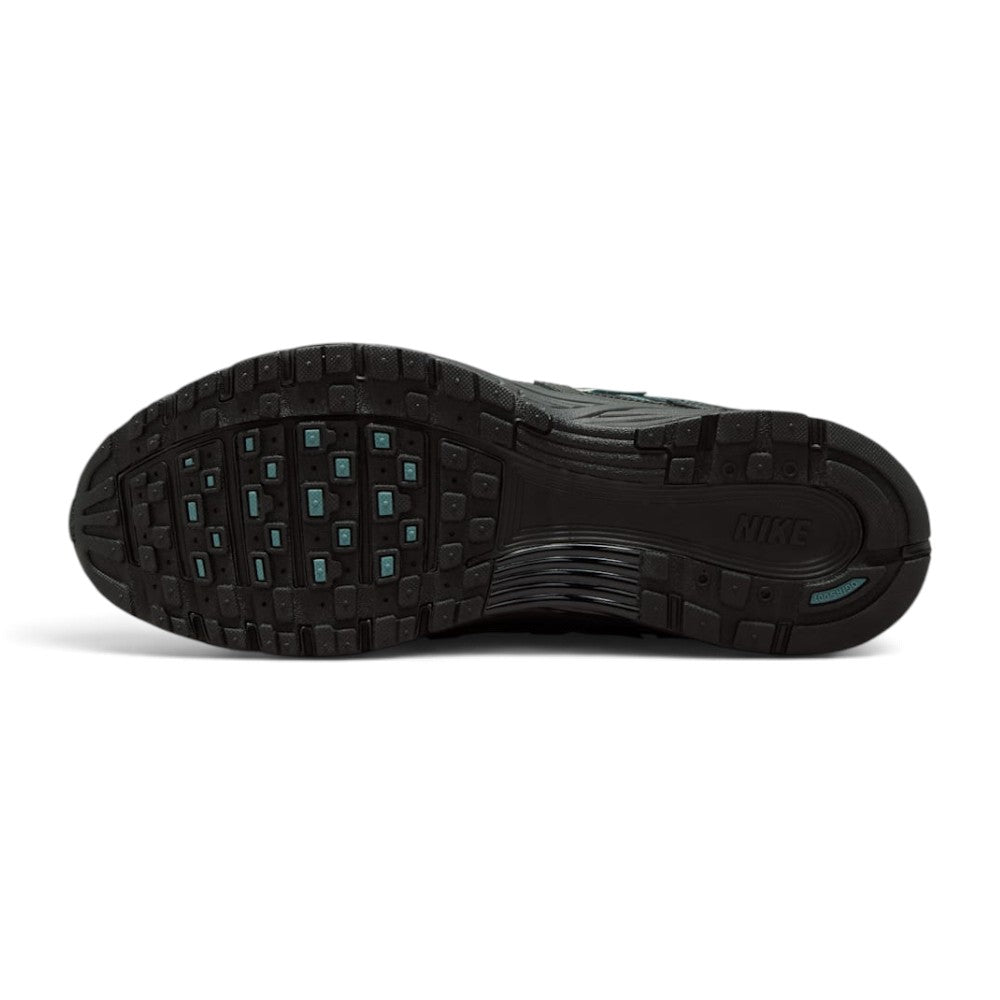 Displays the full-length black rubber outsole, showcasing the multi-pod waffle traction pattern, grooved forefoot flex channels, debossed Nike branding, and subtle teal traction pod insets.