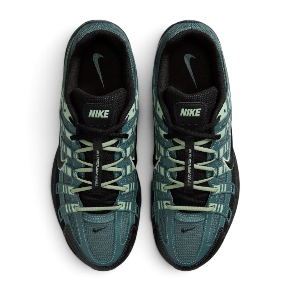 Focuses on the locked-in central lacing layout, displaying the flat Steam pale green laces, vertical tongue webbing stamped with "Bowerman Series" text, black mesh tongues with Nike branding tabs, and cushioned insoles printed with Mineral Slate Swooshes.
