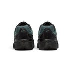 Focuses on the rear profile, displaying the textured black synthetic heel counters, micro Mineral Slate Swooshes, ventilation perforations, and the wide base of the ribbed black foam midsole.