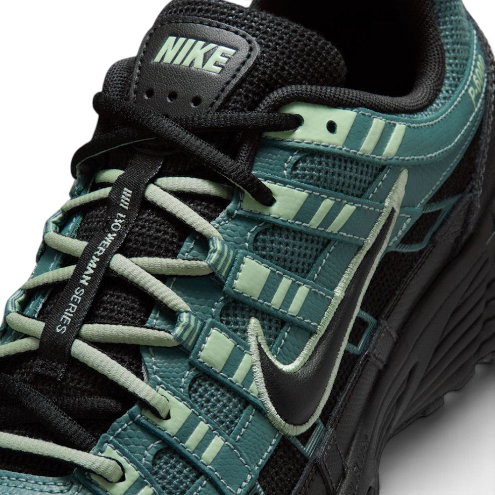 Details the micro-precision of the forefoot area, showing the textured Mineral Slate mesh toe box with mini embroidered Swoosh, Steam green eyelet webbing loops, flat laces, and central "Bowerman Series" tongue strip.