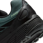 Highlights the "unreal" clean finish of the rear lateral tooling, showcasing the debossed "P-6000" collar script, textured heel panel, ribbed black foam midsole, and lugged rubber outsole tread.